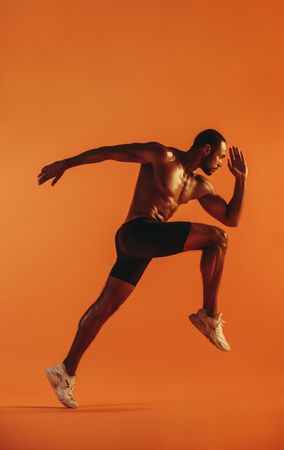 Athletic male model in sprinting position