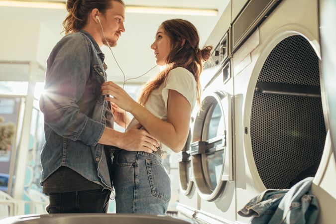 Couple embracing each other in a laundry room with sun flare in the background