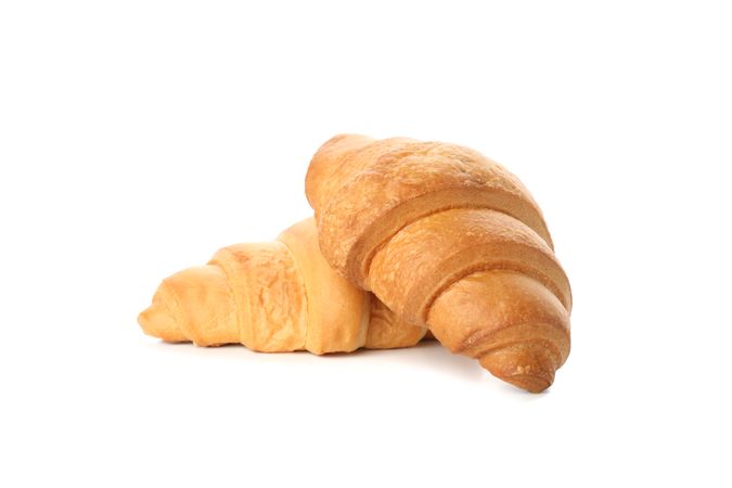 Side view of two croissants isolated on plain background