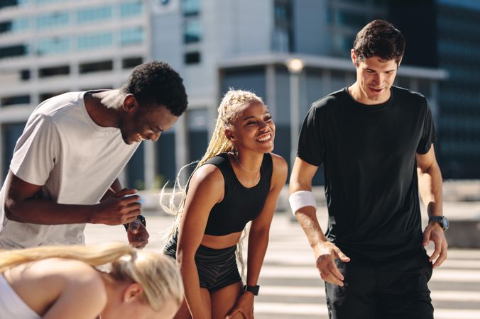 Multi-ethnic group of friends outdoors in the city after workout