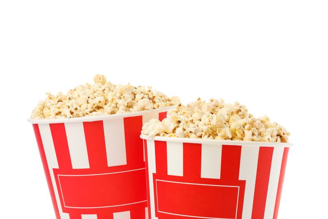 Striped buckets with popcorn isolated on plain background