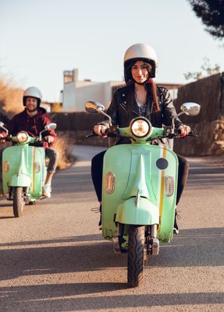 Young people riding motorcycles on city road