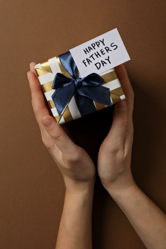 Father's day concept, gifts and greetings, on a brown background.