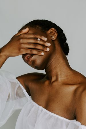 Woman covering her face with hand