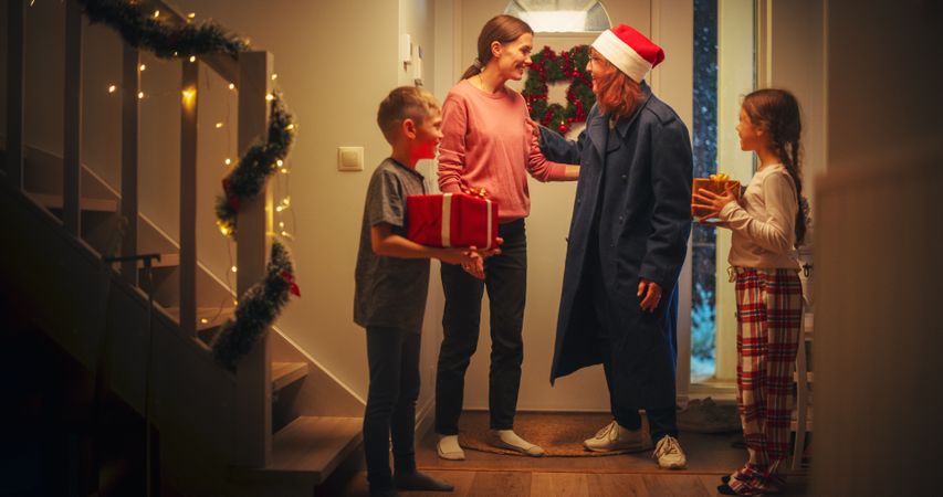 Small Son and Daughter Meeting Grandmother, Who Just Arrived with Festive Holiday Gifts.