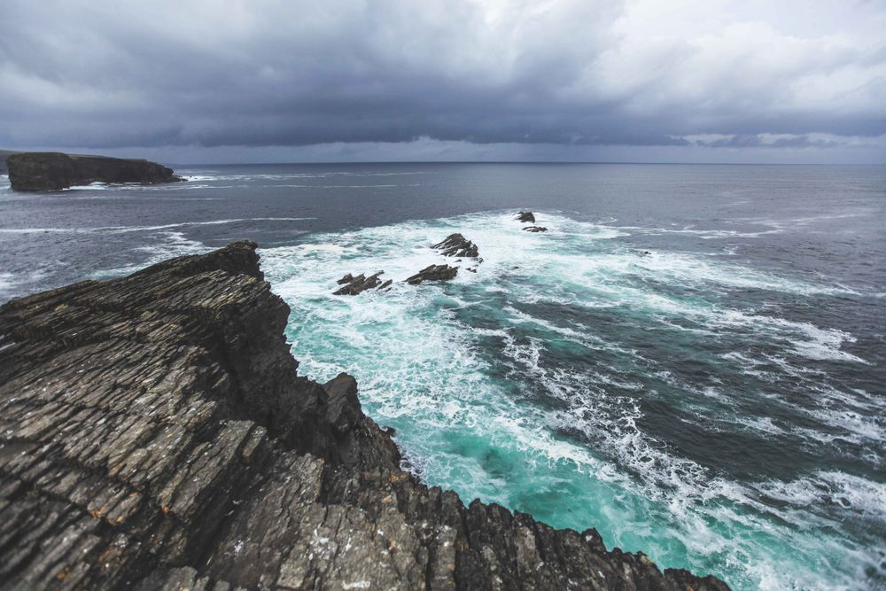 Coastal cliffs looking down on waves breaking
