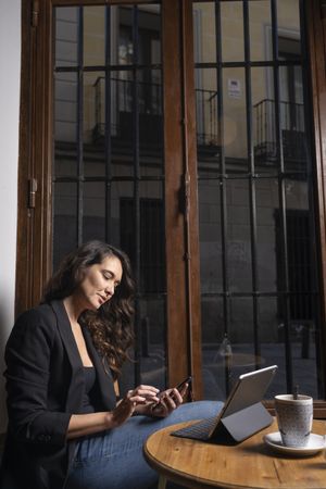 Young female using a mobile phone in cafe