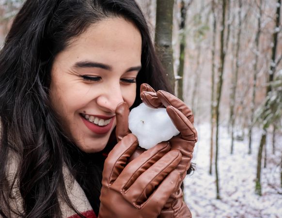 Woman smiling and holding  snow ball
