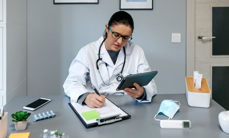 Female doctor doing online consultation with the tablet