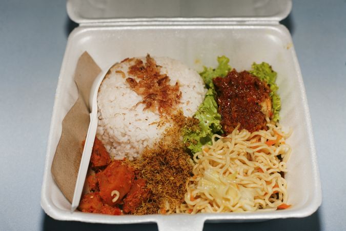 Close up of contents of open take out box full of food