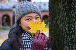 Cheerful young Asian female traveler enjoying sightseeing in Oslo