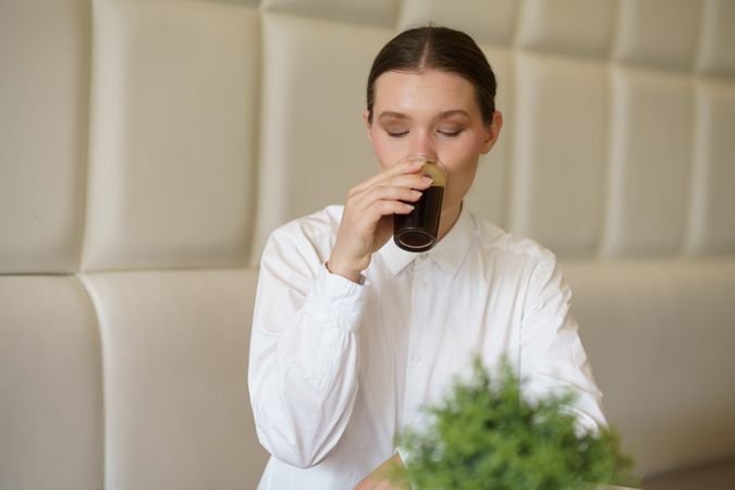 Woman sipping drink