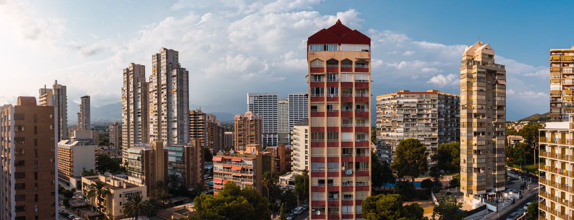 Cityscape against cloudy blue sky