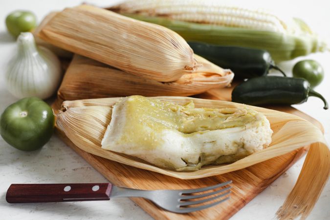 Dough near corn husk and spices for tamales