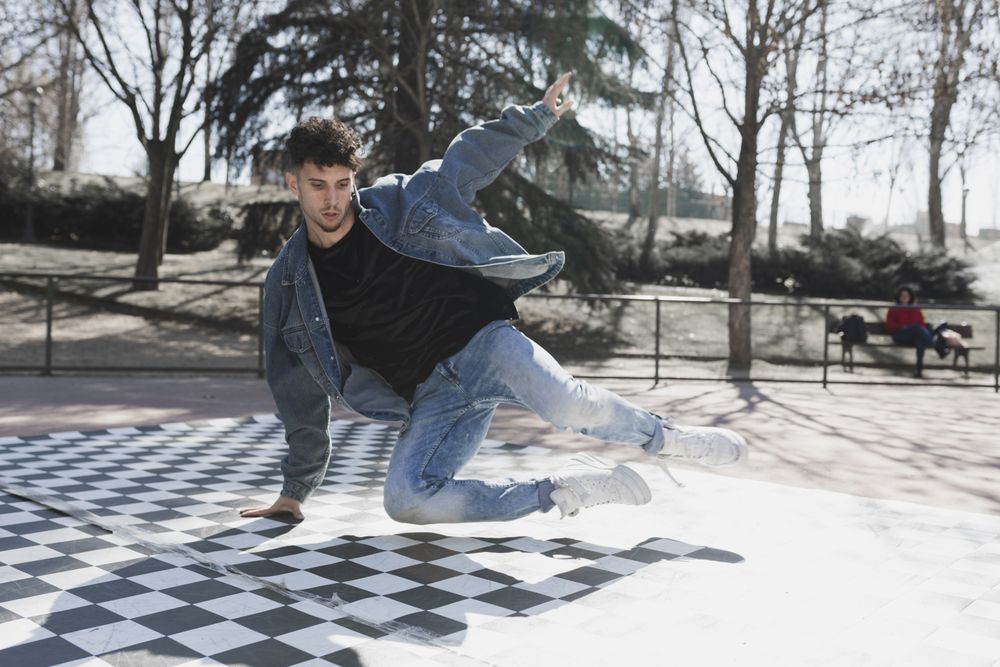 Man dancing break dance in park
