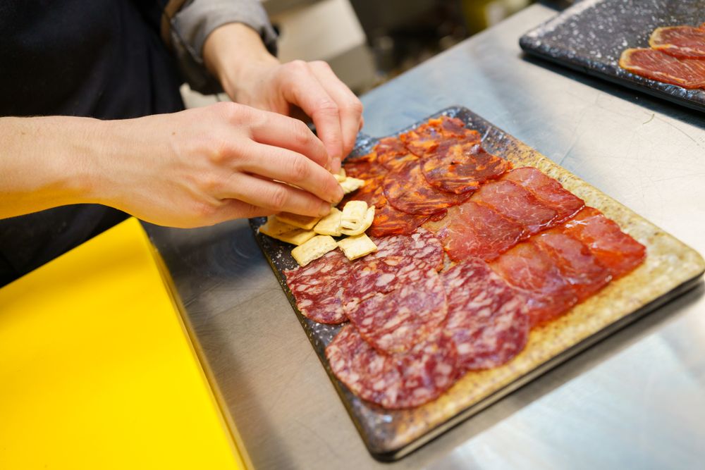 A typical dish of Spanish cuisine with crackers placed on board