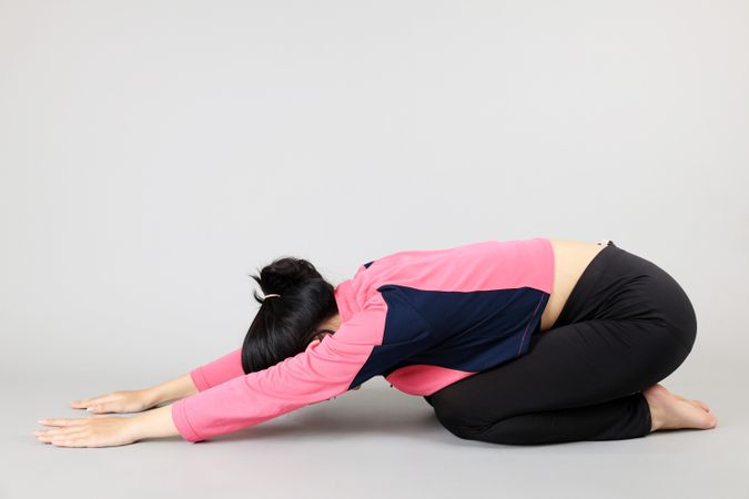 Young Woman doing Yoga Child Pose