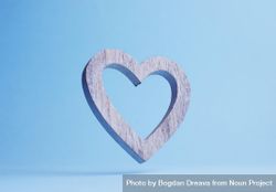 Wooden heart falling over blue background 0LYnD5