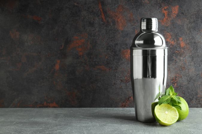 Concept of preparing cocktail, shaker, space for text