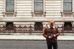 Male tourist walking near old building