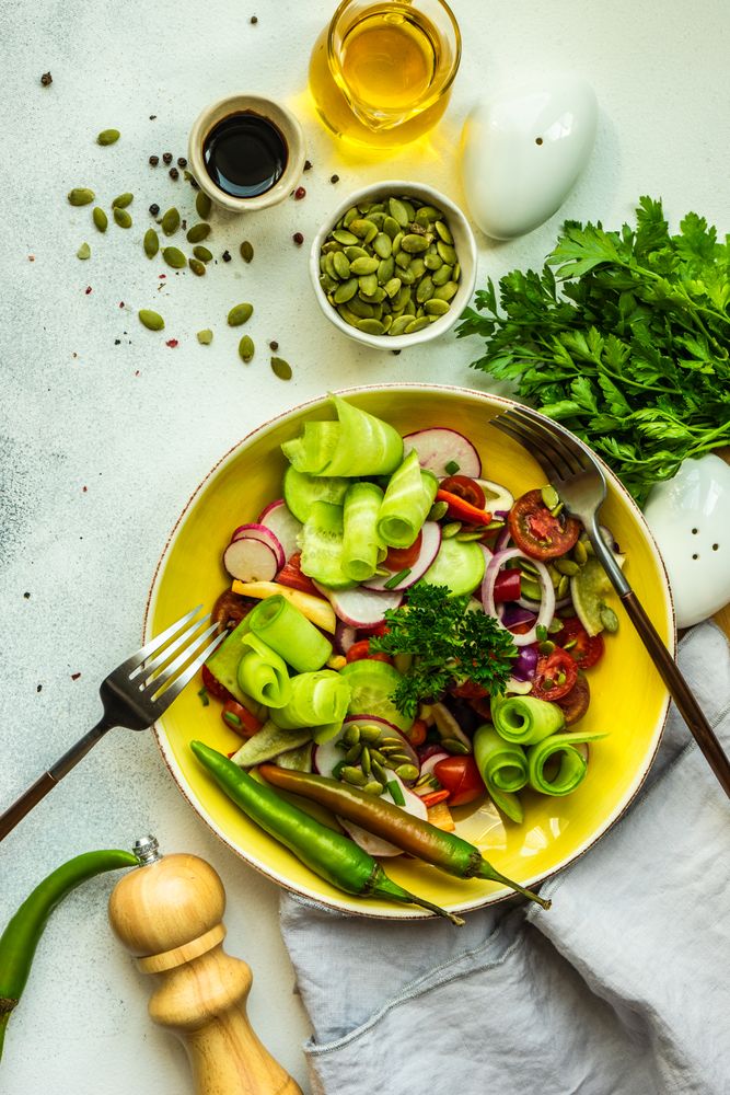 Fresh salad with chopped vegetables served with nuts and garnish