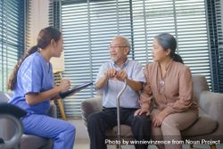 Asian nurse doing a check up for older Asian man at home 5qkklj