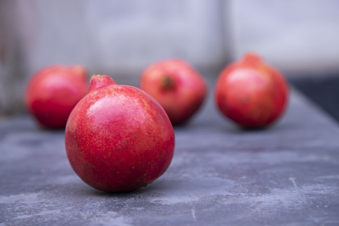 Round pomegranates on a slate board