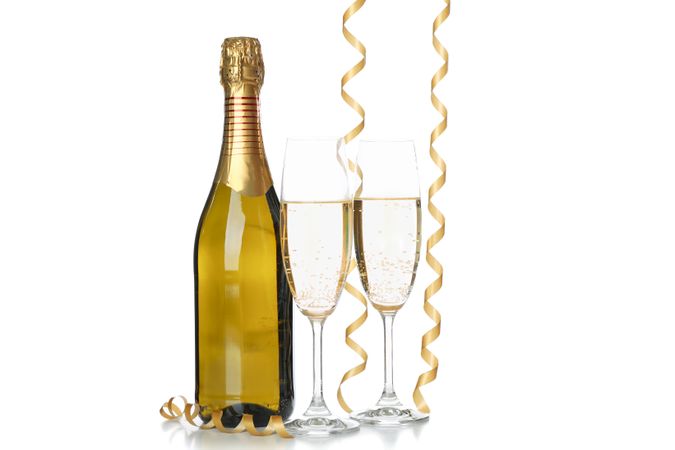 Champagne glasses, bottle and ribbons isolated on light background