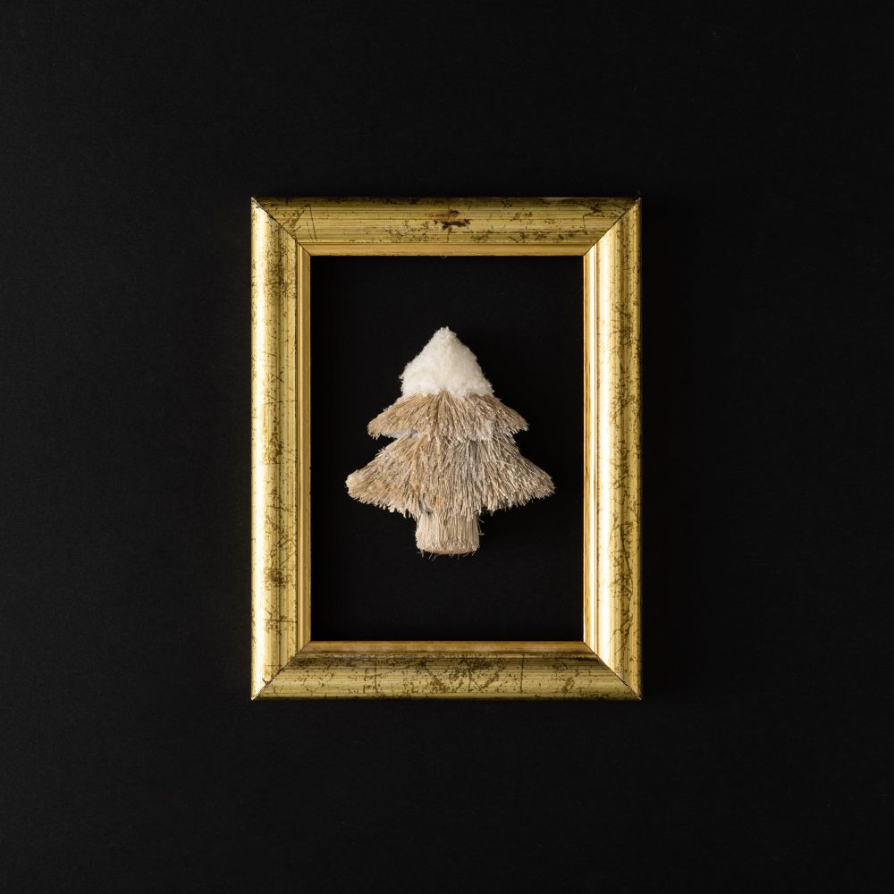 Gold frame with festive tree on dark background
