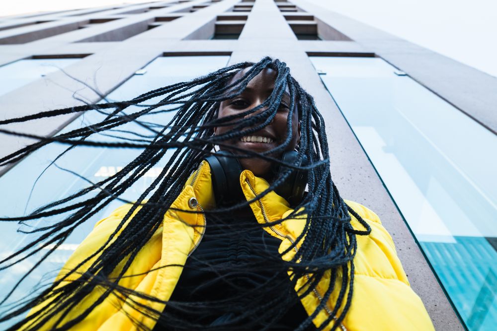 Black woman against skyscraper in city