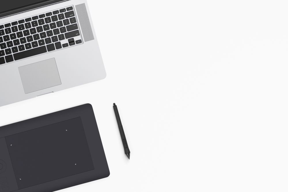 Modern workspace with coffee cup, smartphone, paper, notebook, tablet and laptop copy space
