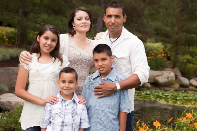 Happy Hispanic Family In the Park