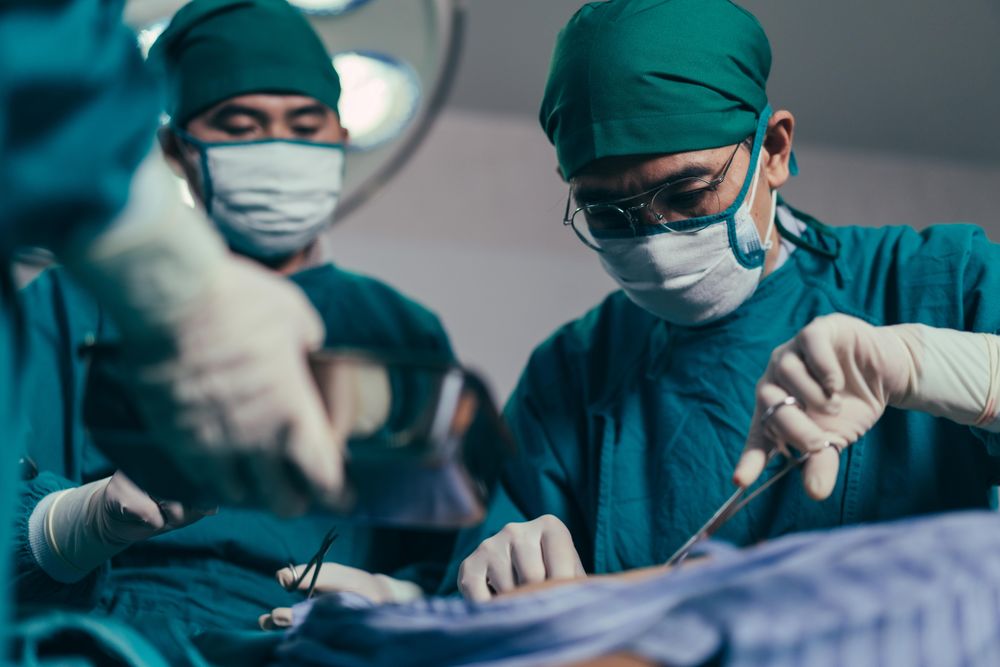 Group of surgeons working to save patient’s life at hospital theatre