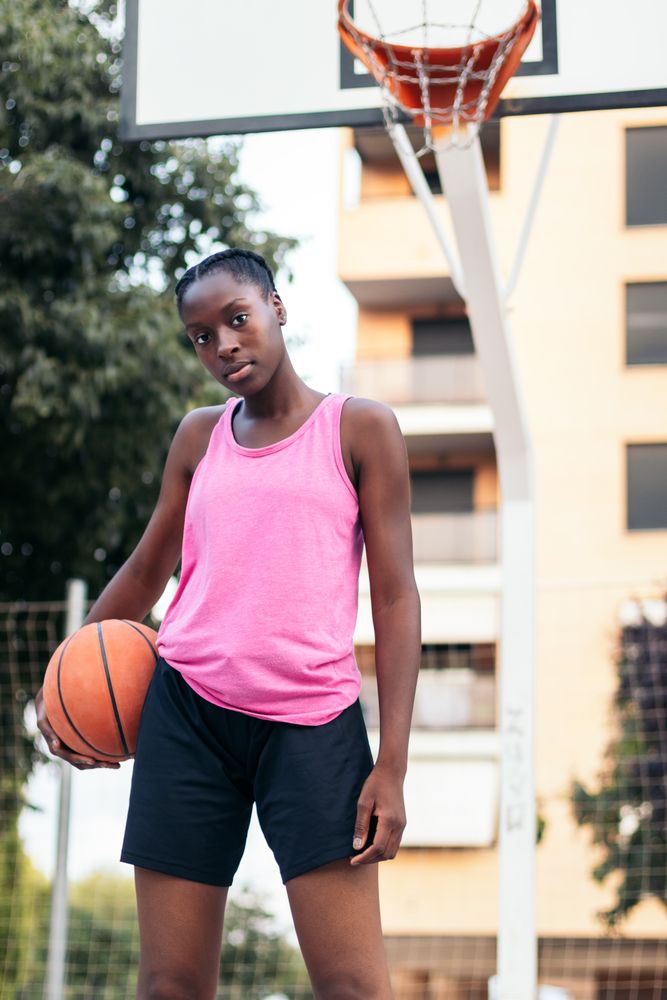 Confident Basketball Player Holding Ball with Determination