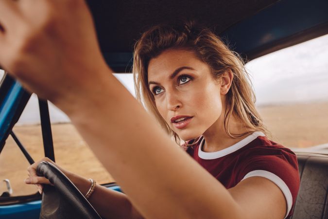 Woman on road trip driving a car