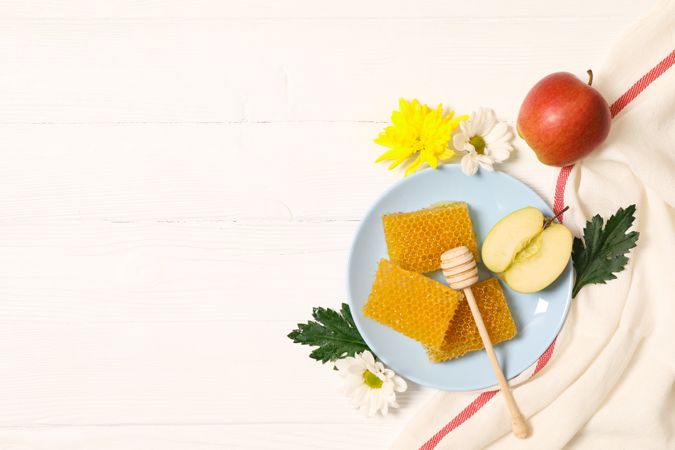 Honey, flowers and apple on wooden background, copy space