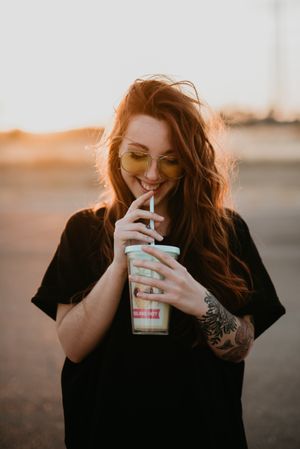 Long haired woman drinking milkshake