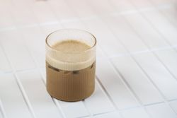 Iced coffee with milk on tiles