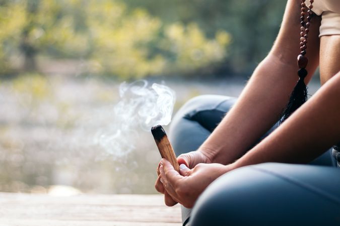Young woman meditating and doing yoga in nature