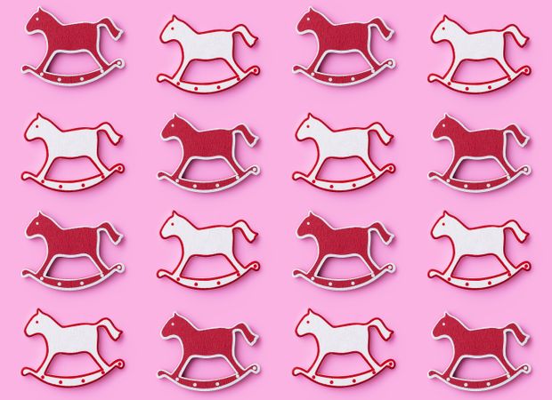 Rocking horse ornaments on pink background