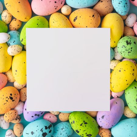 Easter composition made with colorful eggs and paper card