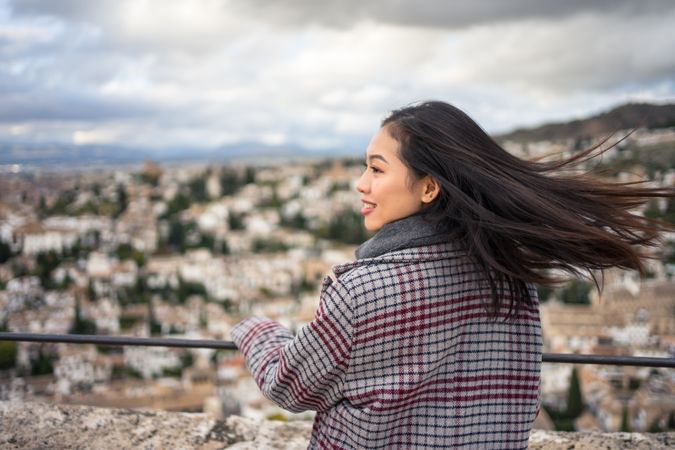 Cheerful woman visiting ancient city