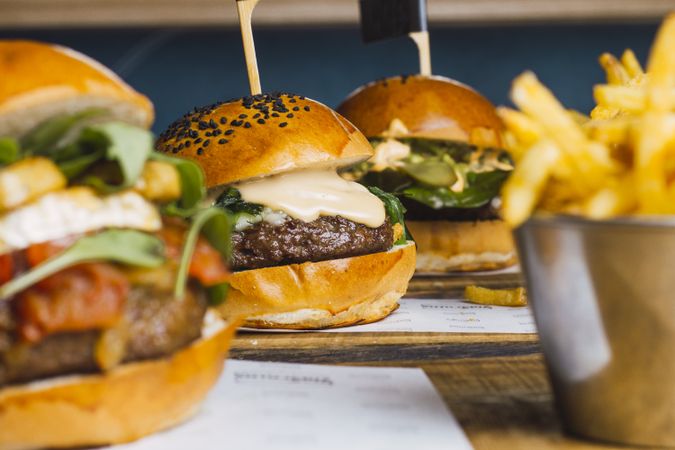 Juicy delicious burger and fried potato on table