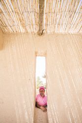 man behind stone wall