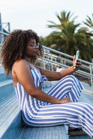Stylish Black woman taking selfie on street
