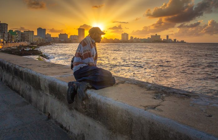 Havana, Cuba - November, 22 2012: man on embankment during sunset