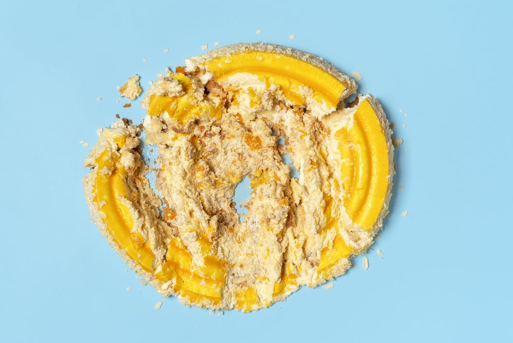Smashed cake top view on blue background