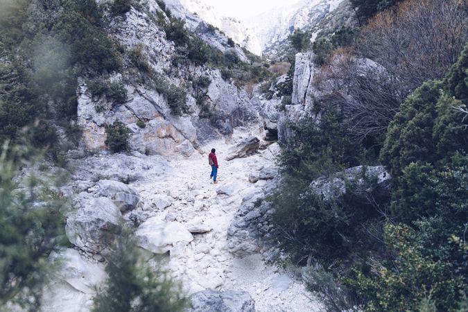 Woman walking between stone hills
