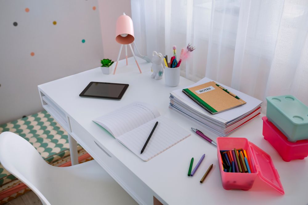 Desk in girl's bedroom decorated in pastel colors