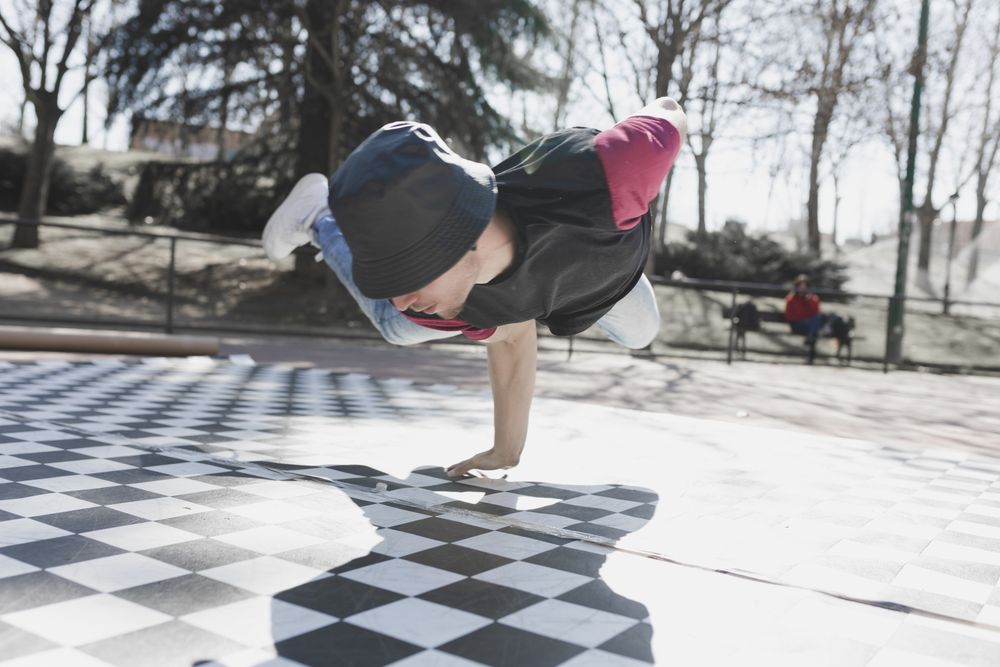 Man dancing break dance in park